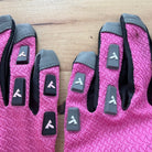 Two TRUCK Float prototype gloves side by side, finger tabs in close-up: the logo reads in opposite directions from one glove to the other